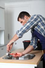 Monterey Plumbing technician tightens sink